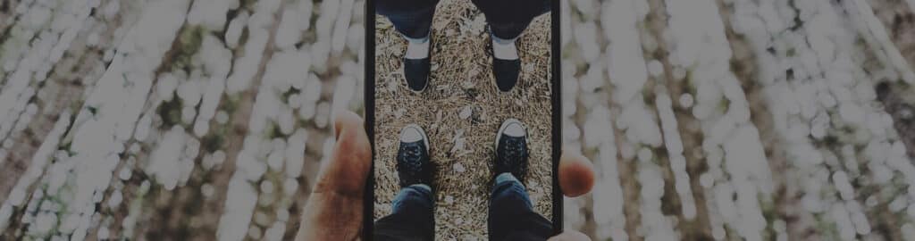 phone screen showing a couple's feet
